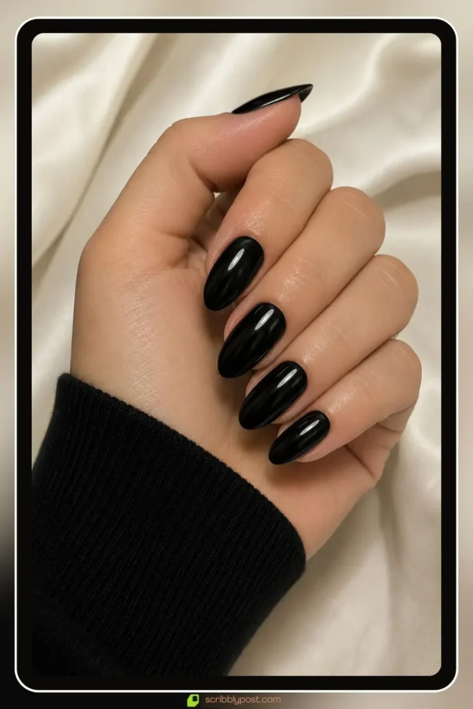 Glossy black base with a thin nude line, Simple Black Nail Designs, edgy minimal manicure
