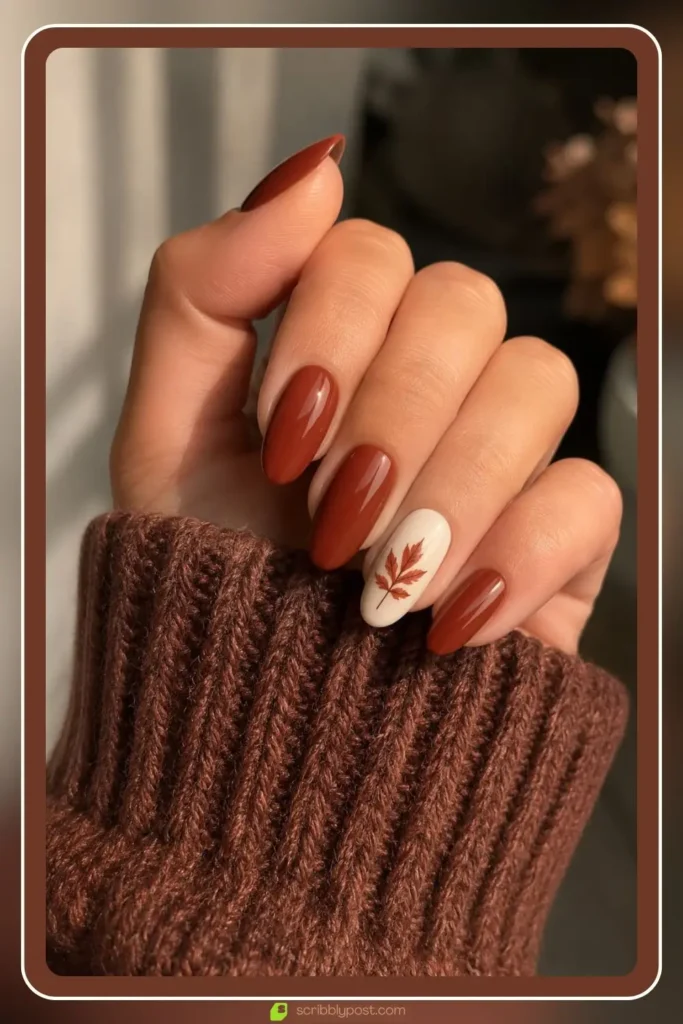 Warm rust base with a single leaf accent, Simple Fall Nail Designs, autumn manicure