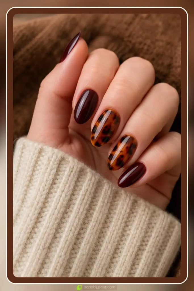Burgundy nails with tortoise shell accent nails in amber and brown