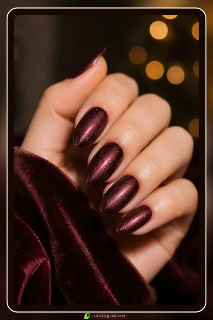 Velvet burgundy nails with soft shimmer glow and plush finish