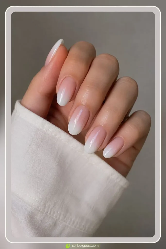 White ombre nails fading from opaque tips to sheer base
