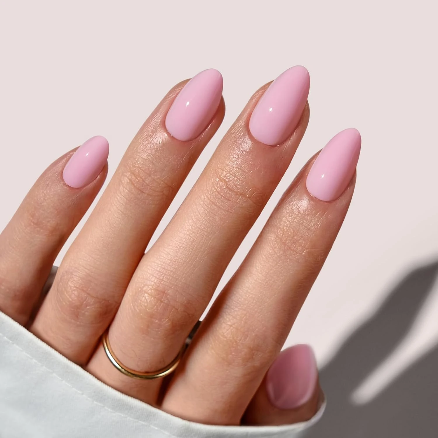 Pink almond press on nails in salon finish