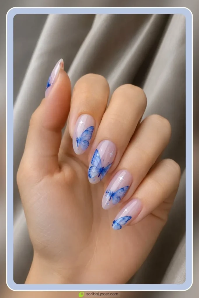 Butterfly Nails Explained: The Technique Plus 15 Designs for 2026 17 Blue butterfly nails with delicate wing detail on light base