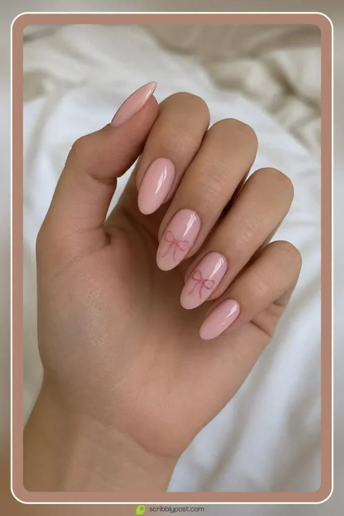 Coquette soft pink bow accent nails in pale pink feminine finish for college