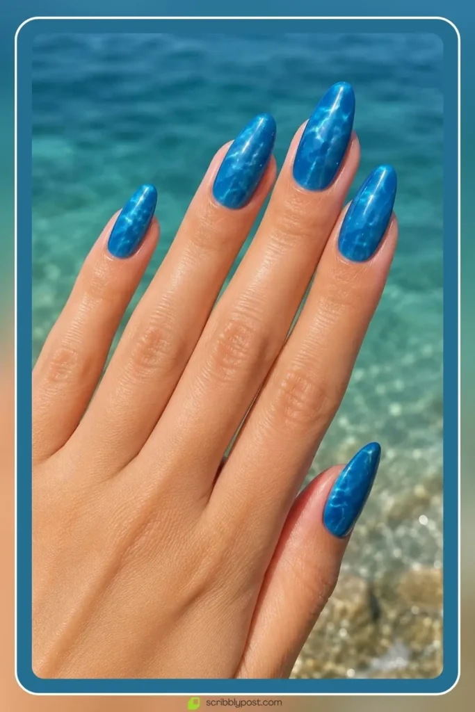 Mermaid Nails Decoded: 16 Ocean-Inspired Sets for 2026 13 Mermaid ocean blue nails in deep saturated aquatic tone