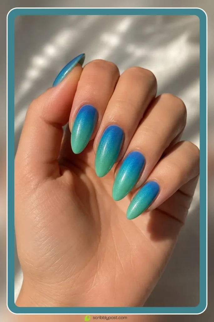 Mermaid Nails Decoded: 16 Ocean-Inspired Sets for 2026 21 Mermaid ombre nails fading between blue and green ocean tones