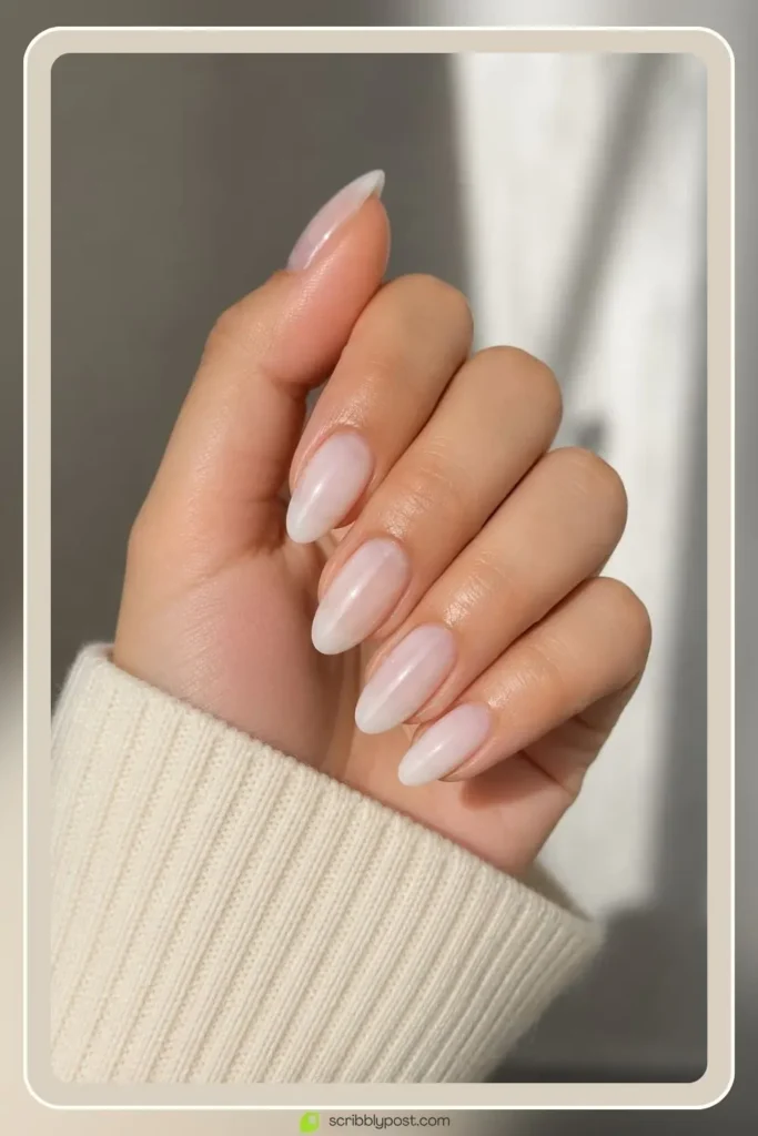 Milky sheer almond nails in translucent soft white finish for school
