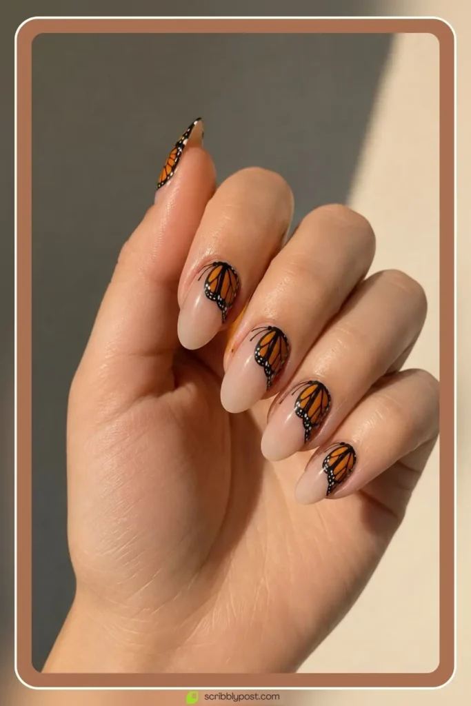 Butterfly Nails Explained: The Technique Plus 15 Designs for 2026 29 Monarch butterfly nails with orange and black wing pattern