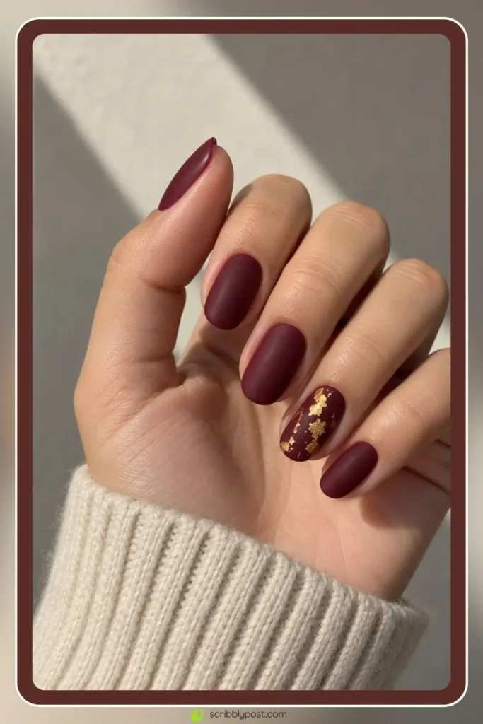 Matte burgundy fall nails with a gold foil accent nail