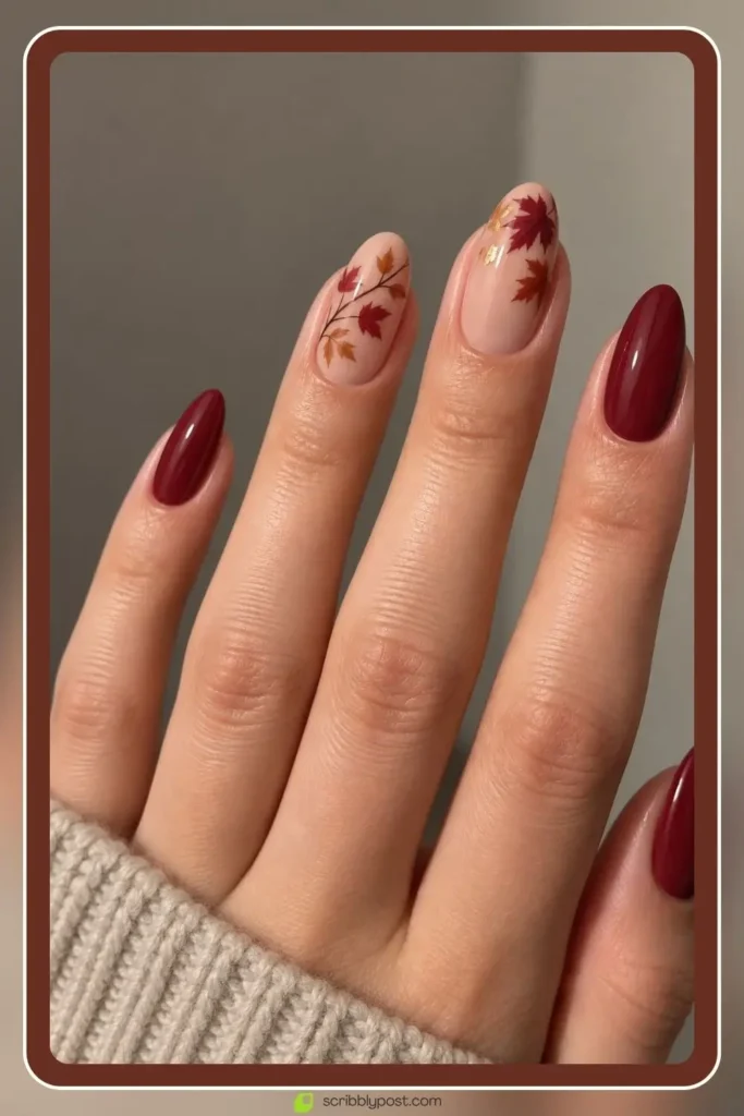 Nude and deep red simple fall nails with maple leaf tips