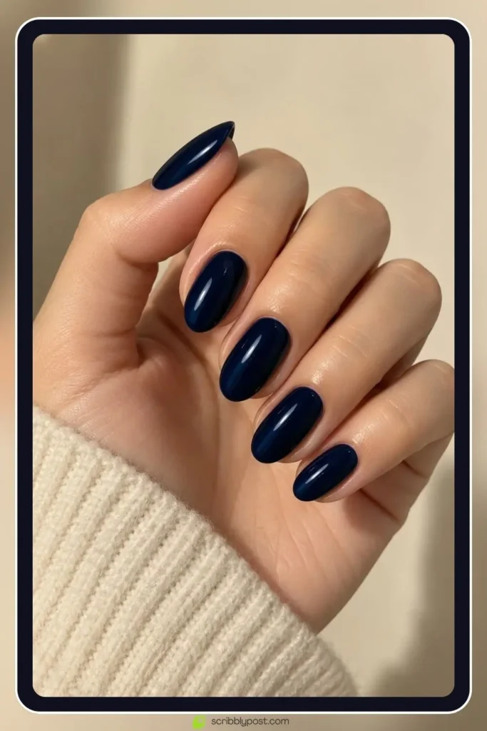 The October Nail Plan: What to Book, When, and How to Fit Halloween Into It 2 October almond nails in a deep midnight blue with a glossy finish